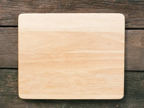 The blank wooden board on old deep brown planks — Stock Photo, Image