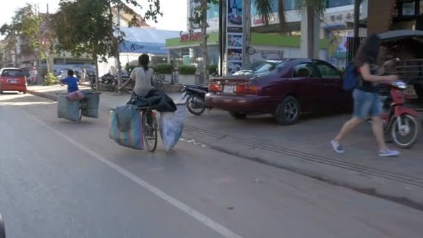 SIEM REAP, CAMBODIA - NOV 2015: Young girl riding bike on street — Stock Video