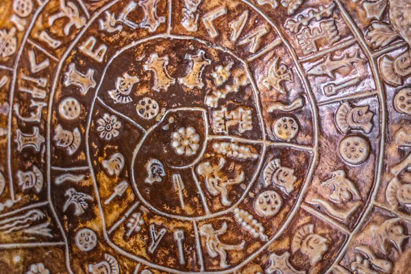 Phaistos diskinin merkez kısmının hiyeroglif arka planı. Phaistos Diski (ayrıca Phaistos Disk, Phaestos Disc olarak da yazılır) Girit adasındaki Minos Sarayı 'ndan ateşlenen kil diski..