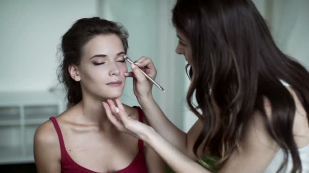 Maquillaje artista hace modelos profesional de maquillaje de ojos — Vídeo de stock