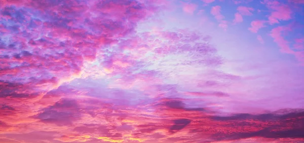 Dramatic purple sky with fluffy clouds