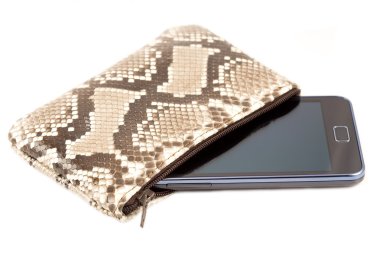Mobile phone in the snake skin case clipart
