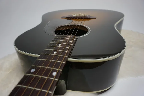 Acoustic guitar with white backdrop