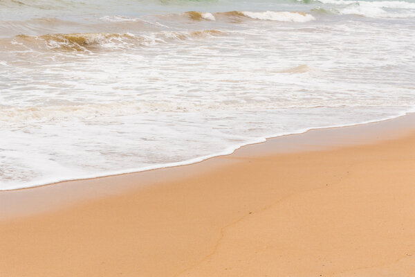 Sea wave and beach on evening.