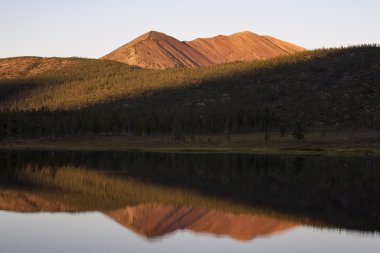 Kırmızı dağ ve göl onun yansıması.