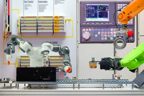 Industrial robotics automation working via conveyor belt on smart factory, terminal and control panel background, industry 4.0