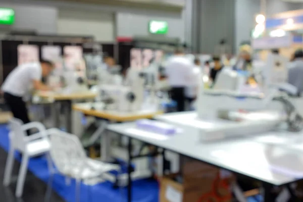 Blurred focus image of labor people, who working on industrial sewing factory for manufacture a garment product, people blurred background