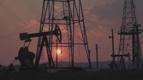 Silhouettes Oil Wells Pumping Sunset — Stock Video