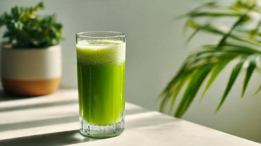 Işık masasında bir bardak taze meyve suyu.