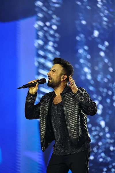 24-01-2026 İstanbul Türkiye: Tarkan mavi konser ışığı altında canlı performans sergiliyor