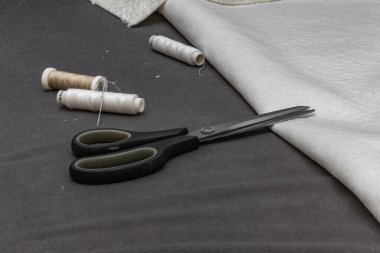 Close up of fitting a white boucl fabric cover on a corner sofa Concept of furniture renovation, upholstery work, and interior design craftsmanship.