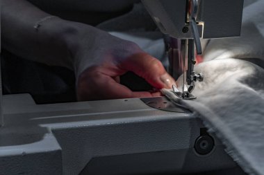 Close up of fitting a white boucl fabric cover on a corner sofa Concept of furniture renovation, upholstery work, and interior design craftsmanship.