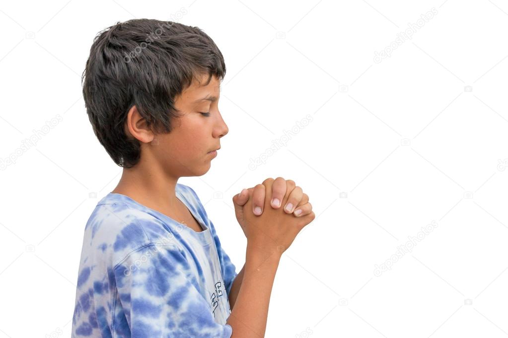 Small religious gypsy child boy praying with folded hands side v