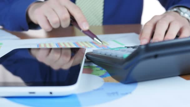 Businessman Working With Graph And Using Digital Tablet And Calculator — Stock Video