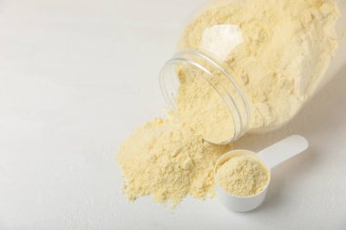 Protein powder. A spoonful of protein powder on a table. Different flavors of whey protein powder. Sports nutrition concept. Gym. Amino acid food supplement, creatine powder. Copy space.