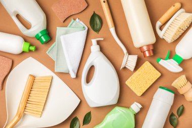 Eco cleaning.Cleaning products on a textured background. Eco-friendly home cleaning. A bottle of natural detergent surfaces, eco brushes, sponges, and rags. Cleaner concept.Cleaning supplies.Flat lay.