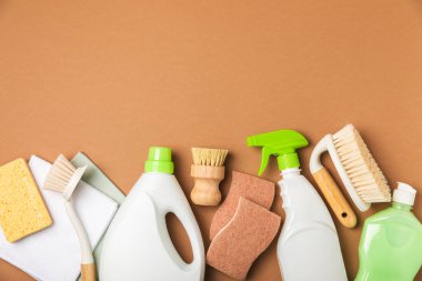 Eco cleaning.Cleaning products on a textured background. Eco-friendly home cleaning. A bottle of natural detergent surfaces, eco brushes, sponges, and rags. Cleaner concept.Cleaning supplies.Flat lay.