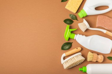 Eco cleaning.Cleaning products on a textured background. Eco-friendly home cleaning. A bottle of natural detergent surfaces, eco brushes, sponges, and rags. Cleaner concept.Cleaning supplies.Flat lay.