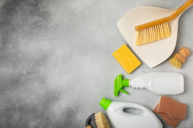 Eco cleaning.Cleaning products on a textured background. Eco-friendly home cleaning. A bottle of natural detergent surfaces, eco brushes, sponges, and rags. Cleaner concept.Cleaning supplies.Flat lay.