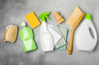 Eco cleaning.Cleaning products on a textured background. Eco-friendly home cleaning. A bottle of natural detergent surfaces, eco brushes, sponges, and rags. Cleaner concept.Cleaning supplies.Flat lay.