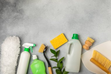 Eco cleaning.Cleaning products on a textured background. Eco-friendly home cleaning. A bottle of natural detergent surfaces, eco brushes, sponges, and rags. Cleaner concept.Cleaning supplies.Flat lay.