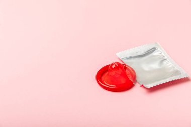 Renkli arka planda prezervatifler. Paketlemede renkli meyve temalı prezervatifler. Güvenli seks konsepti. Doğum kontrol hapı. Farklı doğum kontrol yöntemleri. AİDS önleme. Dünya AIDS Günü. Cinsel sağlık.