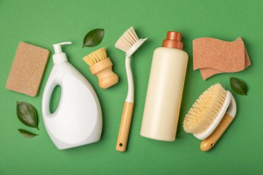 Eco cleaning.Cleaning products on a textured background. Eco-friendly home cleaning. A bottle of natural detergent surfaces, eco brushes, sponges, and rags. Cleaner concept.Cleaning supplies.Flat lay.