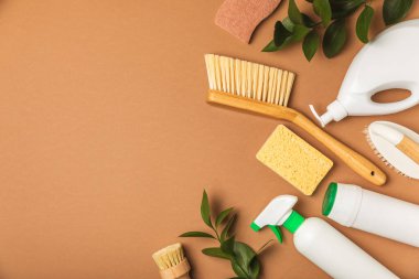 Eco cleaning.Cleaning products on a textured background. Eco-friendly home cleaning. A bottle of natural detergent surfaces, eco brushes, sponges, and rags. Cleaner concept.Cleaning supplies.Flat lay.