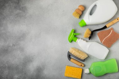 Eco cleaning.Cleaning products on a textured background. Eco-friendly home cleaning. A bottle of natural detergent surfaces, eco brushes, sponges, and rags. Cleaner concept.Cleaning supplies.Flat lay.