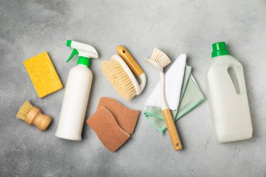 Eco cleaning.Cleaning products on a textured background. Eco-friendly home cleaning. A bottle of natural detergent surfaces, eco brushes, sponges, and rags. Cleaner concept.Cleaning supplies.Flat lay.
