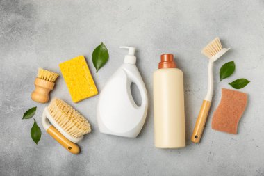 Eco cleaning.Cleaning products on a textured background. Eco-friendly home cleaning. A bottle of natural detergent surfaces, eco brushes, sponges, and rags. Cleaner concept.Cleaning supplies.Flat lay.