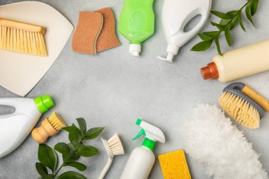 Eco cleaning.Cleaning products on a textured background. Eco-friendly home cleaning. A bottle of natural detergent surfaces, eco brushes, sponges, and rags. Cleaner concept.Cleaning supplies.Flat lay.