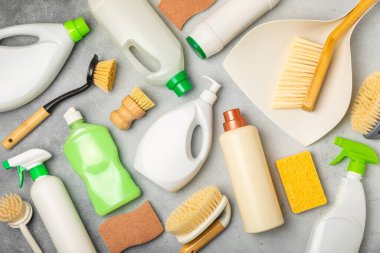 Eco cleaning.Cleaning products on a textured background. Eco-friendly home cleaning. A bottle of natural detergent surfaces, eco brushes, sponges, and rags. Cleaner concept.Cleaning supplies.Flat lay.