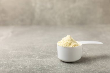 Protein powder. A spoonful of protein powder on a table. Different flavors of whey protein powder. Sports nutrition concept. Gym. Amino acid food supplement, creatine powder. Copy space.