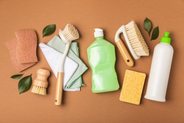 Eco cleaning.Cleaning products on a textured background. Eco-friendly home cleaning. A bottle of natural detergent surfaces, eco brushes, sponges, and rags. Cleaner concept.Cleaning supplies.Flat lay.