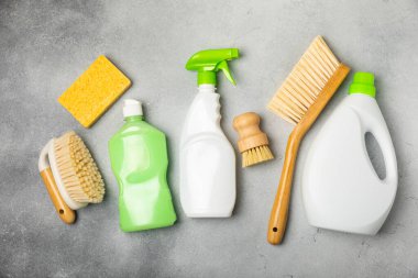 Eco cleaning.Cleaning products on a textured background. Eco-friendly home cleaning. A bottle of natural detergent surfaces, eco brushes, sponges, and rags. Cleaner concept.Cleaning supplies.Flat lay.