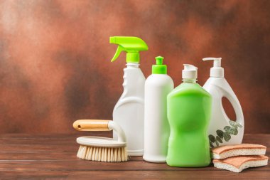 Eco cleaning.Cleaning products on a textured background. Eco-friendly home cleaning. A bottle of natural detergent surfaces, eco brushes, sponges, and rags. Cleaner concept.Cleaning supplies.Flat lay.