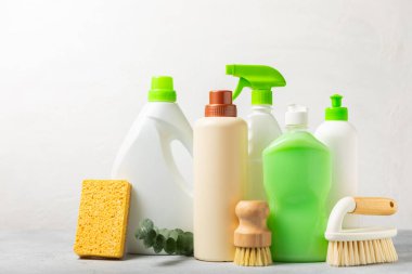 Eco cleaning.Cleaning products on a textured background. Eco-friendly home cleaning. A bottle of natural detergent surfaces, eco brushes, sponges, and rags. Cleaner concept.Cleaning supplies.Flat lay.
