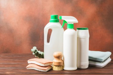 Eco cleaning.Cleaning products on a textured background. Eco-friendly home cleaning. A bottle of natural detergent surfaces, eco brushes, sponges, and rags. Cleaner concept.Cleaning supplies.Flat lay.