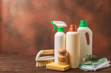 Eco cleaning.Cleaning products on a textured background. Eco-friendly home cleaning. A bottle of natural detergent surfaces, eco brushes, sponges, and rags. Cleaner concept.Cleaning supplies.Flat lay.