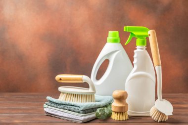 Eco cleaning.Cleaning products on a textured background. Eco-friendly home cleaning. A bottle of natural detergent surfaces, eco brushes, sponges, and rags. Cleaner concept.Cleaning supplies.Flat lay.