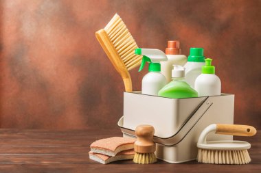 Eco cleaning.Cleaning products on a textured background. Eco-friendly home cleaning. A bottle of natural detergent surfaces, eco brushes, sponges, and rags. Cleaner concept.Cleaning supplies.Flat lay.