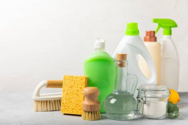 Eco cleaning.Cleaning products on a textured background. Eco-friendly home cleaning. A bottle of natural detergent surfaces, eco brushes, sponges, and rags. Cleaner concept.Cleaning supplies.Flat lay.