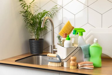 Mutfağın arka planında eko temizlik ürünleri var. Çevre dostu ev temizliği. Bir şişe doğal deterjan yüzeyi, eko fırçalar, süngerler ve paçavralar. Daha temiz bir kavram. Temizlik malzemeleri..