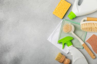 Eco cleaning.Cleaning products on a textured background. Eco-friendly home cleaning. A bottle of natural detergent surfaces, eco brushes, sponges, and rags. Cleaner concept.Cleaning supplies.Flat lay.