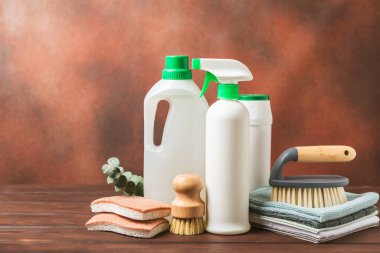 Eco cleaning.Cleaning products on a textured background. Eco-friendly home cleaning. A bottle of natural detergent surfaces, eco brushes, sponges, and rags. Cleaner concept.Cleaning supplies.Flat lay.