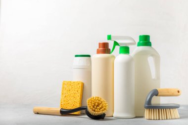 Eco cleaning.Cleaning products on a textured background. Eco-friendly home cleaning. A bottle of natural detergent surfaces, eco brushes, sponges, and rags. Cleaner concept.Cleaning supplies.Flat lay.