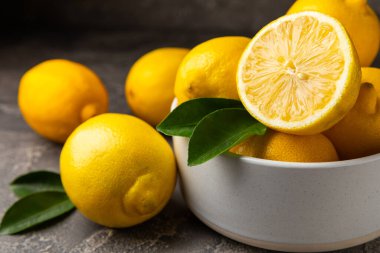 Tahta bir masada limon. Bir dilim taze limon. Turunçgil yapraklı taze limon. Limon suyu. Yemek ve içecek malzemeleri hazırlanıyor. Sağlıklı beslenme. Metin için C vitamini alanı.