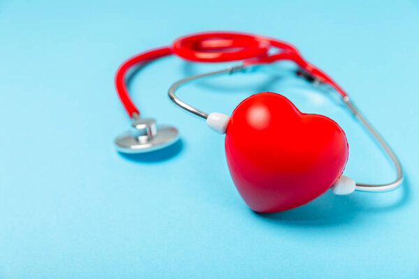 Cardiology. Stethoscope heart. Red heart with doctor's stethoscope on background, hospital life insurance concept, World Heart Health Day. Doctor Day. Medical assistance. Heart disease. Heart attack. Space for Text. Copy space. Flatlay.