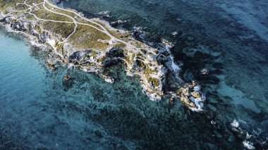 Isla Mujeres, Cancun, Mexico - Beautiful blue ocean with a rocky shoreline. The water is calm and the sky is clear